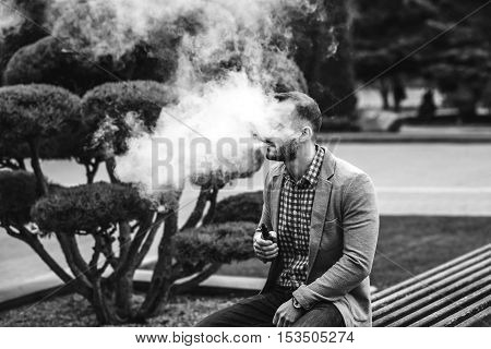 Men With Beard Vaping Electronic Cigarette Outdoor