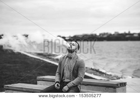 Men With Beard Smoking Electronic Cigarette Outdoor