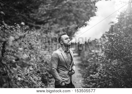 Men With Beard Smoking Electronic Cigarette Outdoor