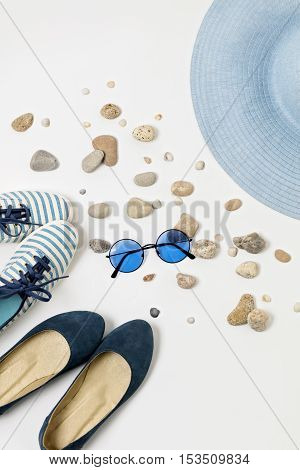 Fashion accessories in blue colors - hat shoes and glasses.