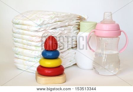 accessories for baby diapers on white background banny a bottle of water cream