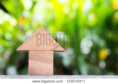 Wooden toy as dream house concept with blurred green blackground