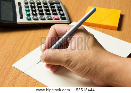Opened blank note book background with business man hold pen for writing