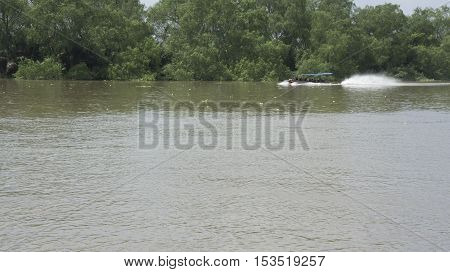 riverside countryside evening reflection light boat fast