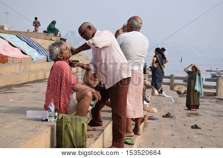 VARANASI, UTTAR PRADESH, INDIA - FEBRUARY 17, 2016 - Unidentified indian people doing morning activities on the ghats of Varanasi, the spiritual capital of India