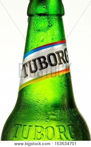 Minsk Belarus August 23 2016. Cold bottle of Tuborg Green Beer with drops isolated on white. Tuborg northern suburb of Copenhagen Denmark