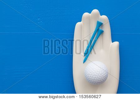 Detail of artifical hand with golf equipments - Flat Lay Photography