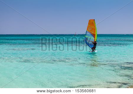 Elafonisi Island Crete Greece - June 26 2016: The windsurfer are moving in the Libyan Sea ( part of the Mediterranean Sea) on the beautiful beach of Elafonisi with pink sand.