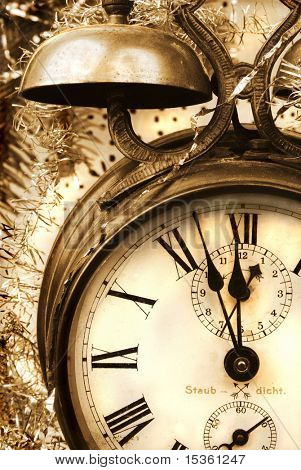 Vintage alarm-clock in sepia tone. New Year celebration