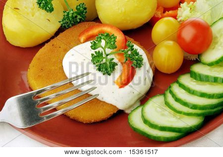 Gebratene panierte Käse-Steak mit Kartoffeln und Gemüse