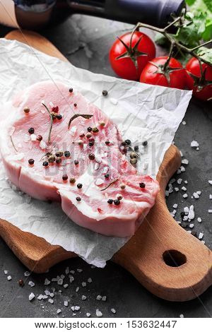 Raw fresh marbled meat Steak and seasonings on dark marble background