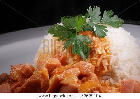 Sausage Stroganoff with rice and leaf parsley
