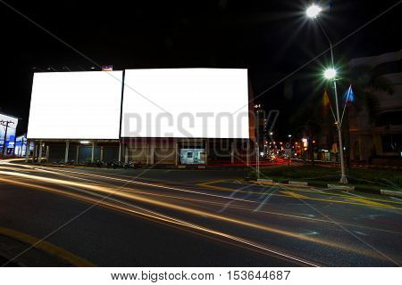 blank billboard and light in city at night timefor advertisement