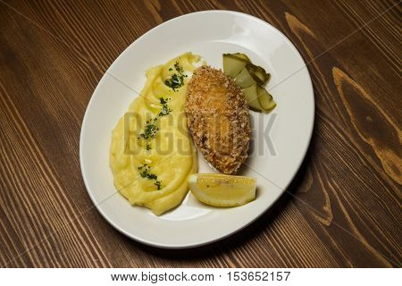 steak with mashed potatoes and pickled cucumber
