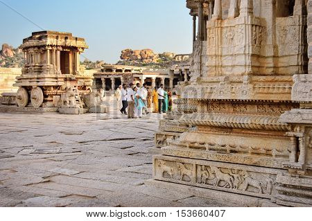 Hampi, India - November 19, 2012: Stone chariot in courtyard of Vittala Temple at sunset overcast sky in Hampi Karnataka India.