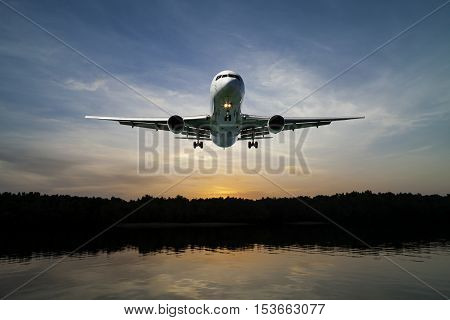 Airplane flying in the sky tropical sea at sunset time