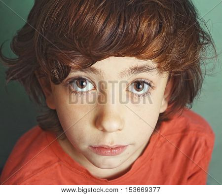 preteen handsome boy expressive close up serious portrait with big eyes