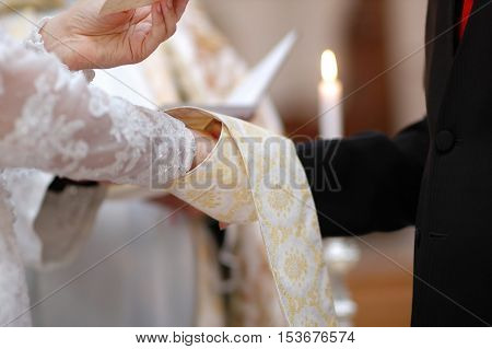 Bride And Groom's Hands And Priest's Cassock