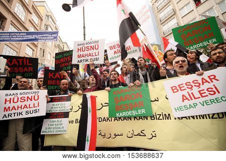 ISTANBUL,TURKEY-DECEMBER 2: Unidentified Syrians living in Istanbul protest the regime of Bashar Essad in front of Syrian Consulate on December 2, 2011 in Istanbul,Turkey.