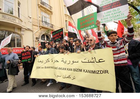 ISTANBUL,TURKEY-DECEMBER 2: Unidentified Syrians living in Istanbul protest the regime of Bashar Essad in front of Syrian Consulate on December 2, 2011 in Istanbul,Turkey.