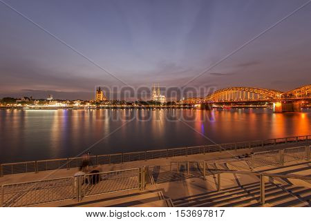 Illuminated Cologne Cathedral and bridge at night in Cologne, Fisheye perspective