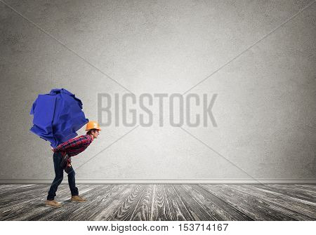 Builder man carrying paper ball on his back