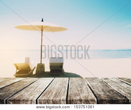 The Beach Holidays, wooden table top on blurred defocus blue sea and white sand beach in sunrise background
