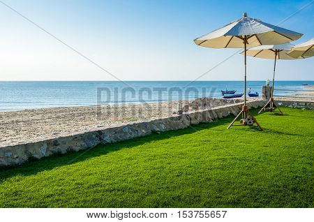 View of the beautiful beach resort with lounge umbrellas for vacations in Cha Am, Phetchaburi Province, Thailand.