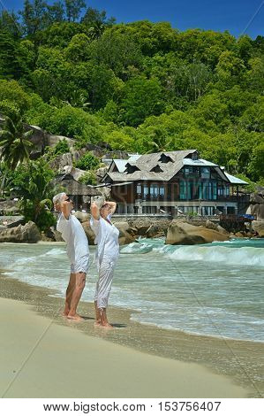 Happy elderly couple rest at tropical beac