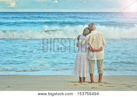 Happy elderly couple rest at tropical beach