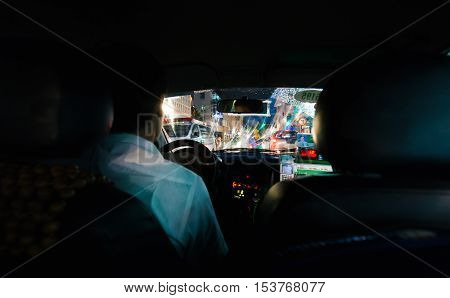 Hanoi Vietnam - September 20 2016: Low key photo of looking out from Vietnam taxi to busy night traffic of Hanoi's down town.