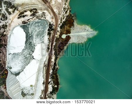 Aerial view - blue water in pond, sandy career