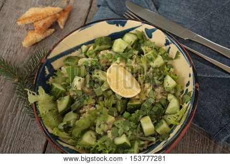 vegan healthy salad with bulgur, cucumber, avocado and crispy toast
