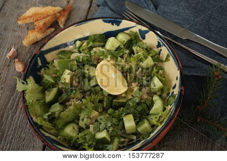 vegan healthy salad with bulgur, cucumber, avocado and crispy toast