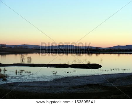 Shadows reflected in the stagnant water in the evening silence