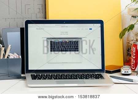 PARIS FRANCE - OCT 28 2016: Apple Computers website on new MacBook Pro Retina with OLED touch bar in a geek creative room showcasing new professional laptop - 15 inch model with touch bar seen from above