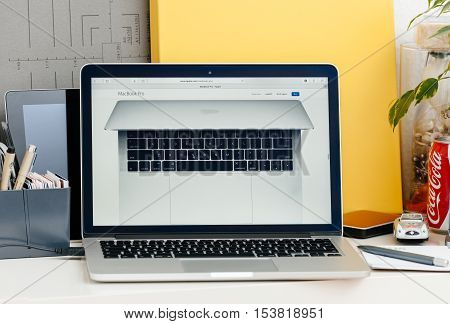 PARIS FRANCE - OCT 28 2016: Apple Computers website on new MacBook Pro Retina with OLED touch bar in a geek creative room showcasing new professional laptop - detail of laptop seen from above