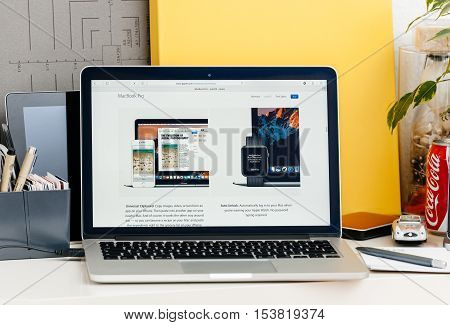 PARIS FRANCE - OCT 28 2016: Apple Computers website on new MacBook Pro Retina with OLED touch bar in a geek creative room showcasing new professional laptop - detail of advantages of using apple Watch and Universal Clipboard