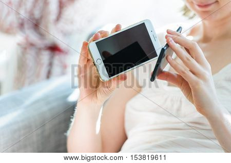 PARIS FRANCE - SEP 29 2016: New Apple iPhone 7 being compared by woman with Microsoft Lumia Surface phone in terms of size and specs and sound quality. New Apple iPhone tends to become one of the most popular smart phones in the world in 2016
