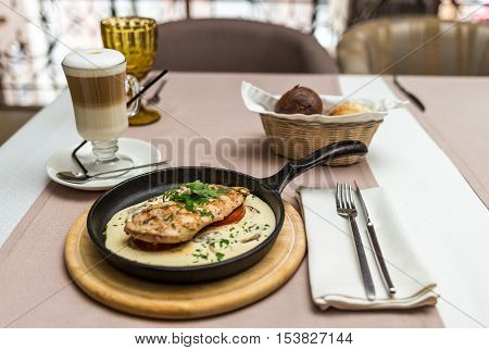 chicken fillet in a creamy mushroom sauce in a frying pan