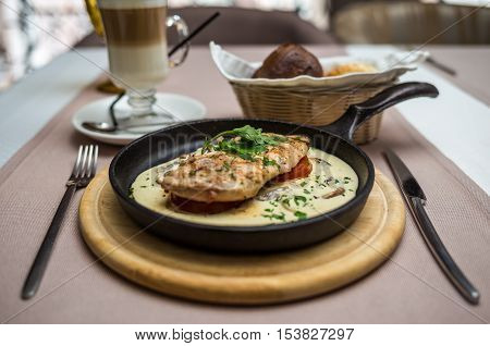 chicken fillet in a creamy mushroom sauce in a frying pan