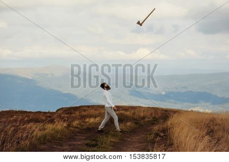Man Throws Axe On Mountain