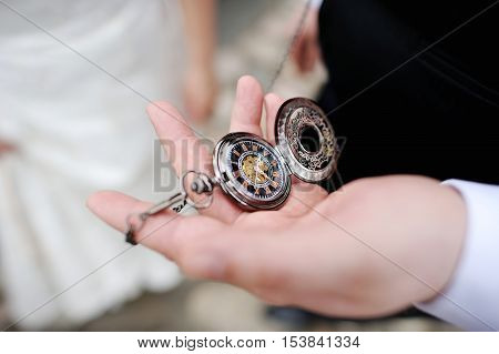 A Man Holding An Antique Pocketwatch