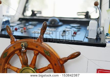 Steering wheel of a sailboat on summer day