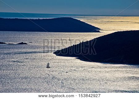 Sailing at Adriatic archipelago at sunset silhouette view Dalmatia Croatia