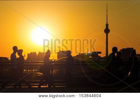 people berlin skyline and tv tower at sunset
