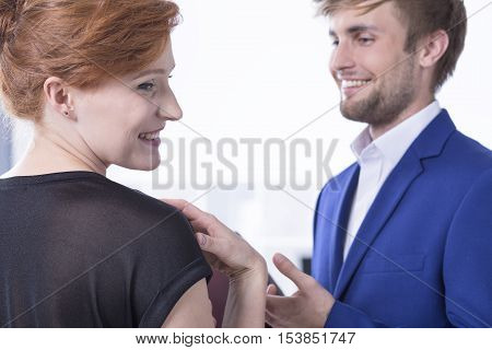 Elegant man looking at his hed haired workmate