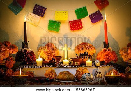 Traditional mexican Day of the dead altar with cempasuchil flowers and candles.
