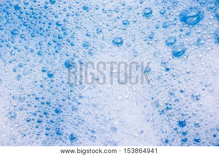 Abstract background of soap foam, suds, shower. Blue background. soft focus, macro view