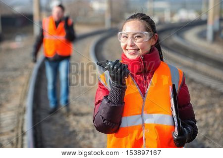 Man and a woman railroad workers maintaing railway